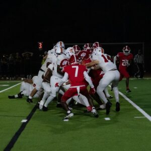 American football players in a scrum on the field